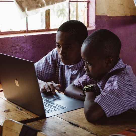 Young Boys using Laptop while Studying